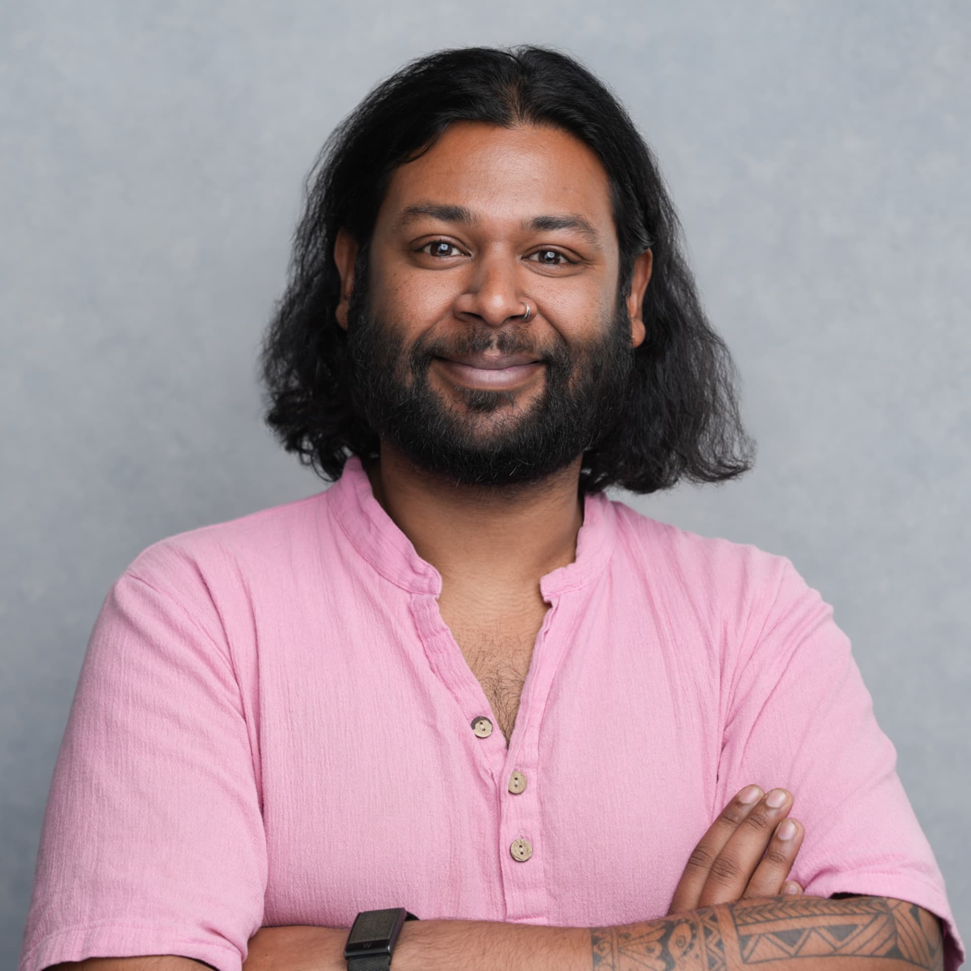 Moiz Arenpurwala, The Growth Gremlin, in a studio portrait with arms crossed
